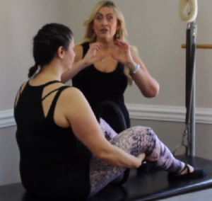 Sabrina Vaz and Dr. Jessica Pizano preparing for an abdominal exercise