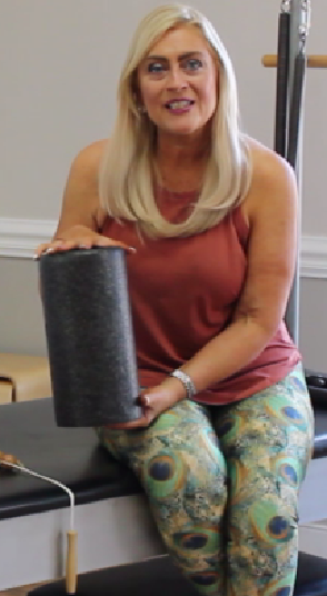 Sabrina Vaz holding a Pilates roller